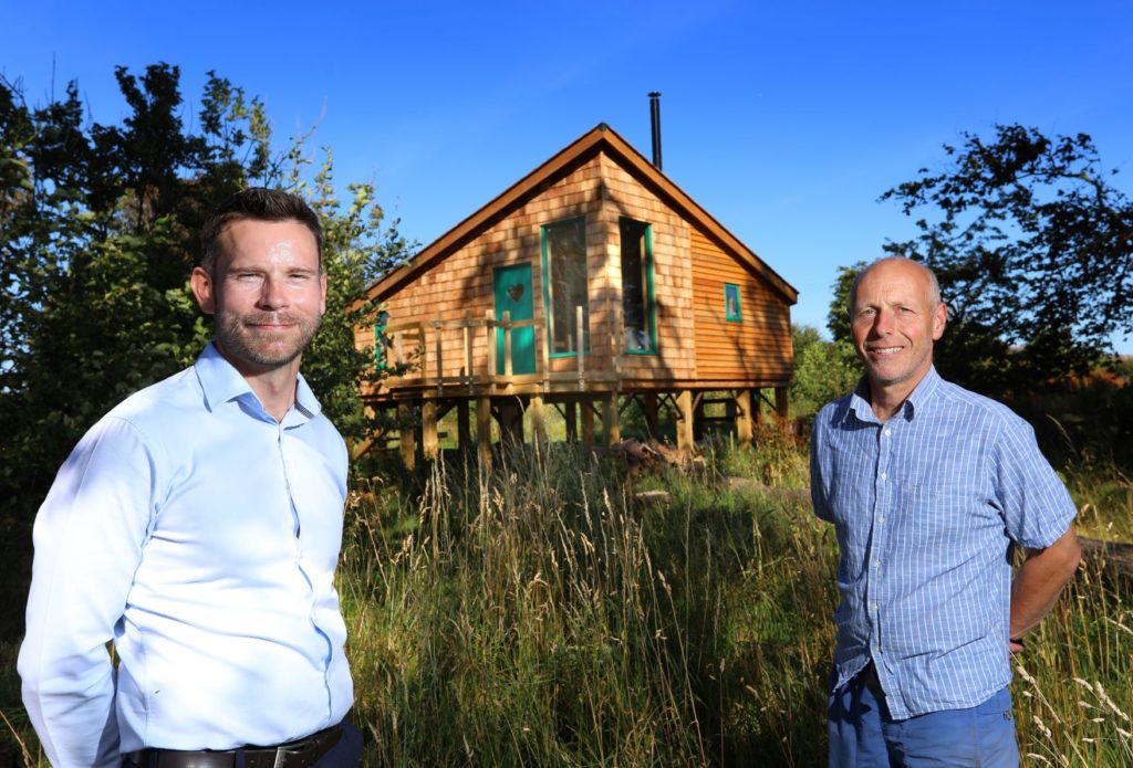 Investment Executive Jonathan Armitage of NEL Fund Managers with Dave Harris-Jones of Laverock Law Cottages and Glamping in front of Laverock Law glamping cabin